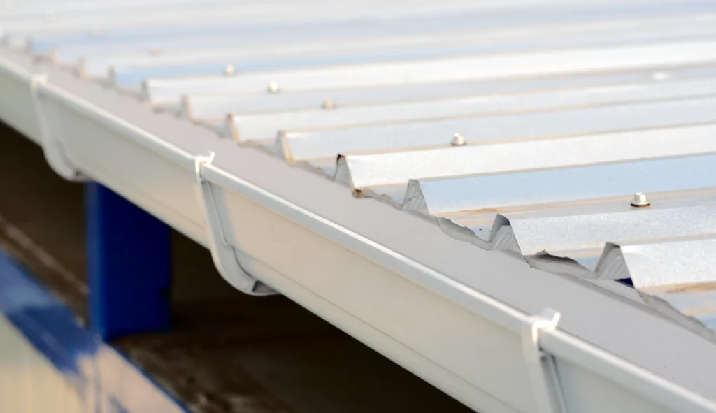 Before-and-after gutter replacement system showing new seamless gutters